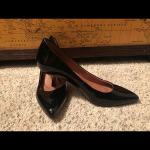 Corso Como black patent leather pumps.
